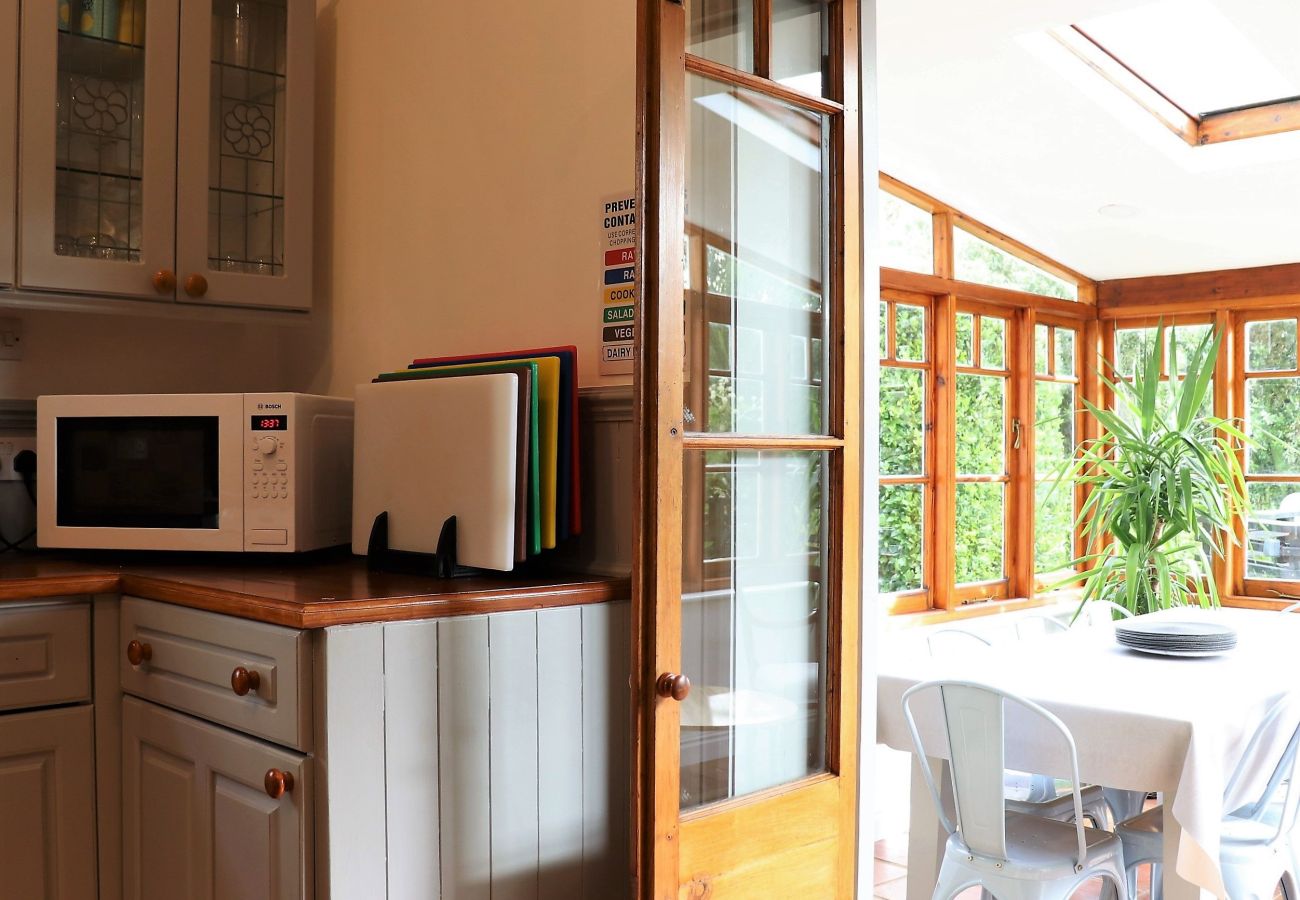 Dine in the light and airy conservatory leading to garden