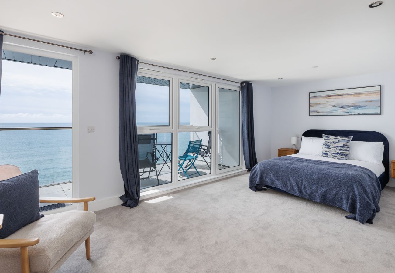 Spacious bedroom opening onto balcony with ocean views at Culver Sands, Isle of Wight