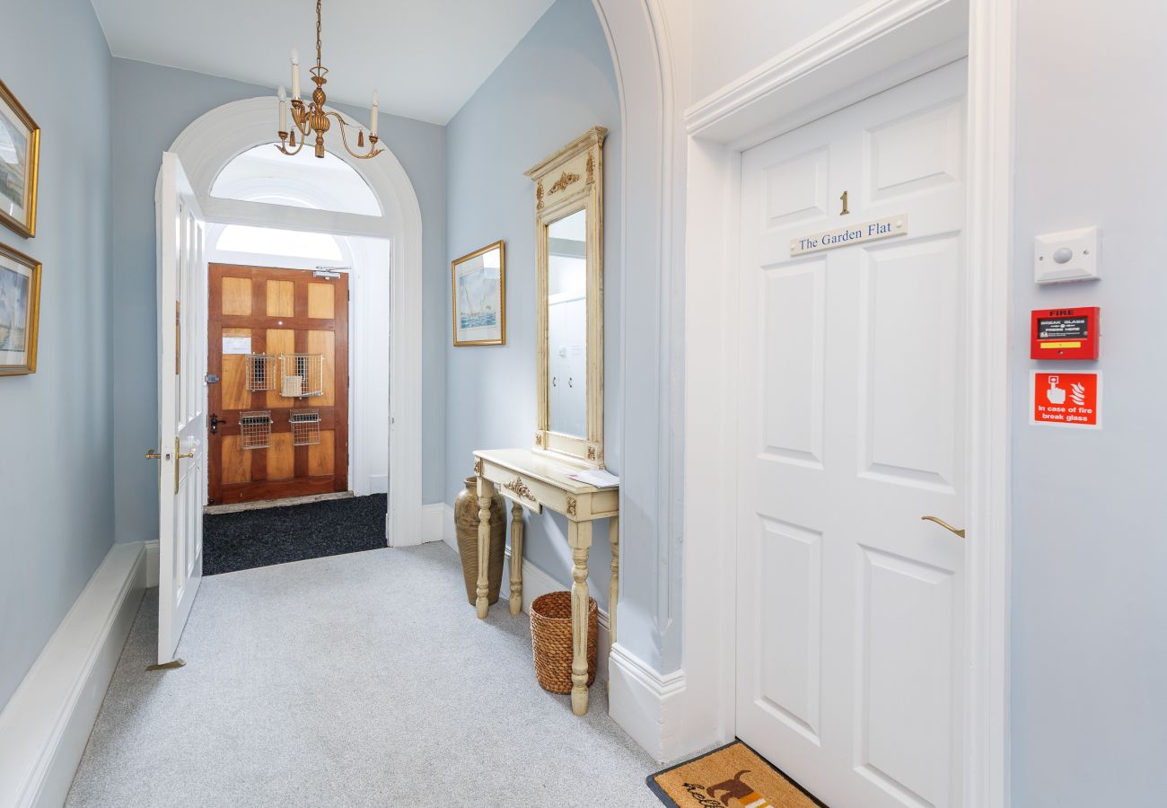 Guests entering the communal hallway of Cowes Garden Apartment
