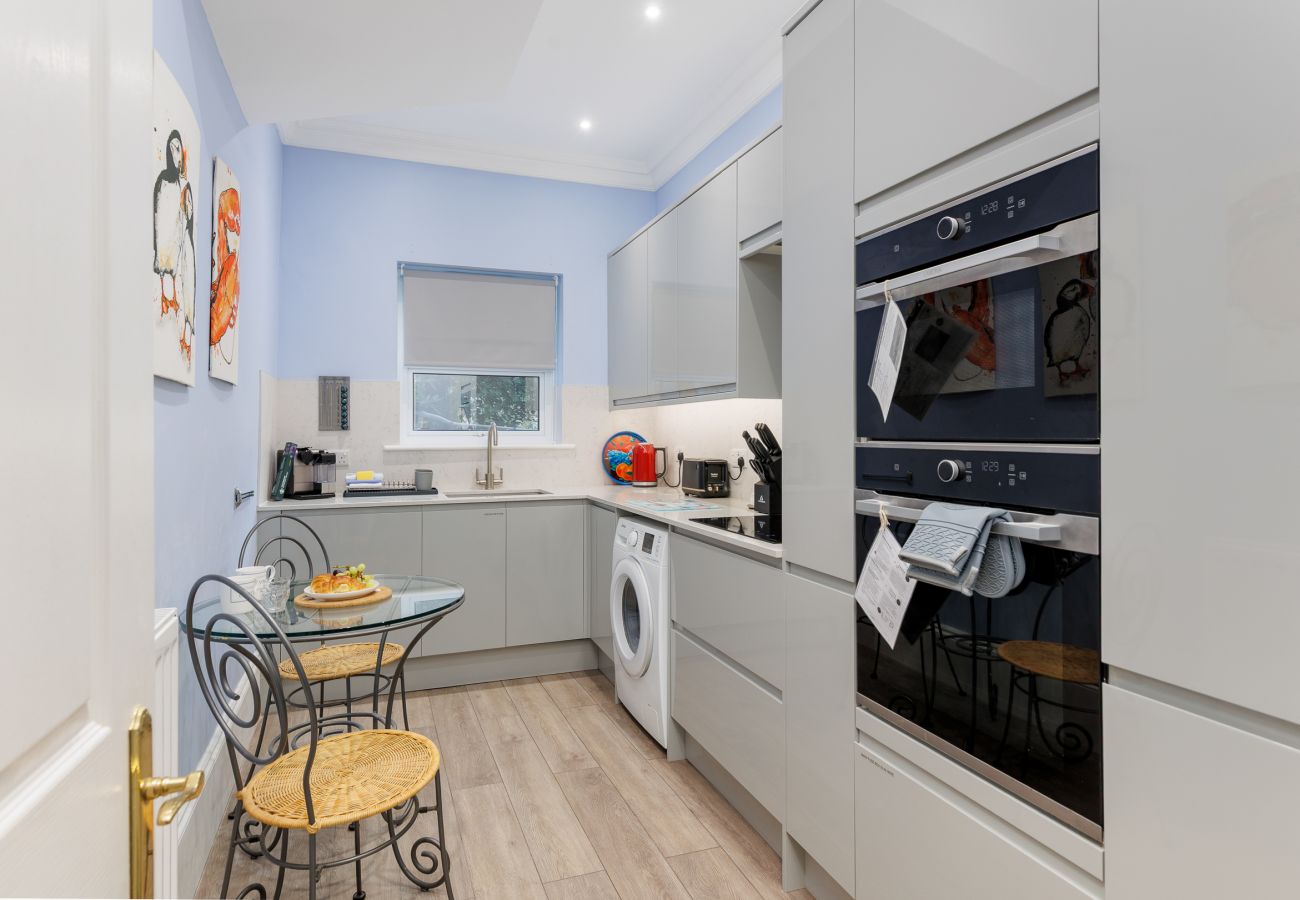 Stylish kitchen at Cowes Garden Apartment featuring contemporary design