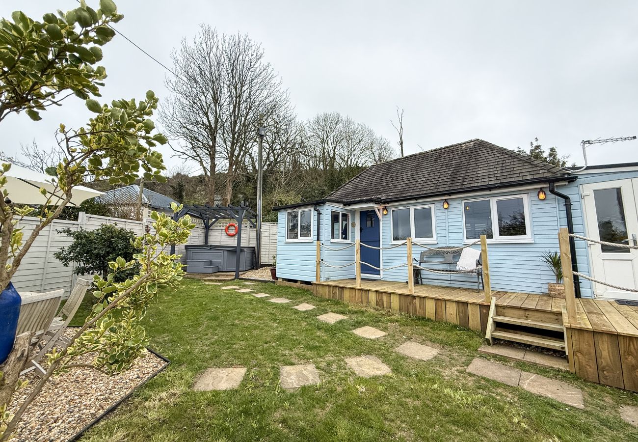 Garden and terrace at Red Cedars with outdoor seating and sea views