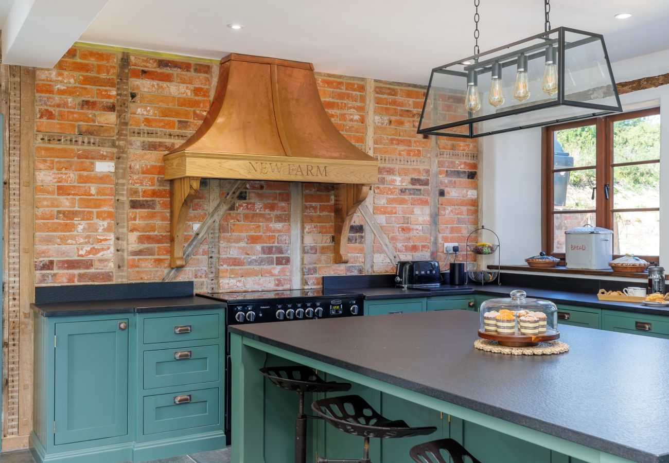 Large fully equipped kitchen with breakfast bar at The Farmhouse at Nunwell holiday home on the Isle of Wight
