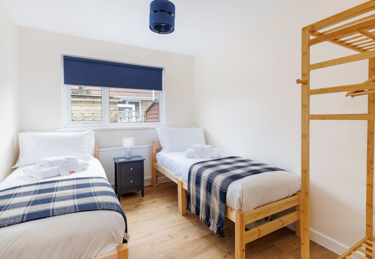 Bright and comfortable twin bedroom in holiday property