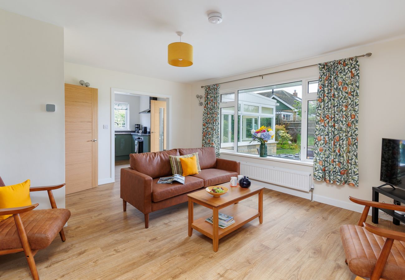 Living room with views over the garden in modern holiday home