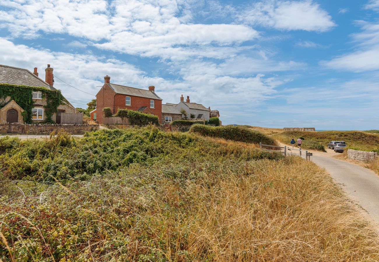 Exterior of Moon Chine Cottage with the coastal footpath nearby on the Isle of Wight.