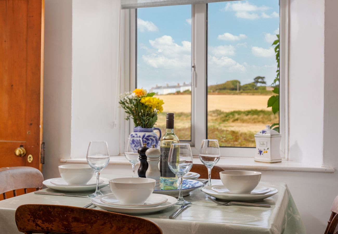Dining table overlooking countryside views at Moon Chine Cottage on the Isle of Wight.
