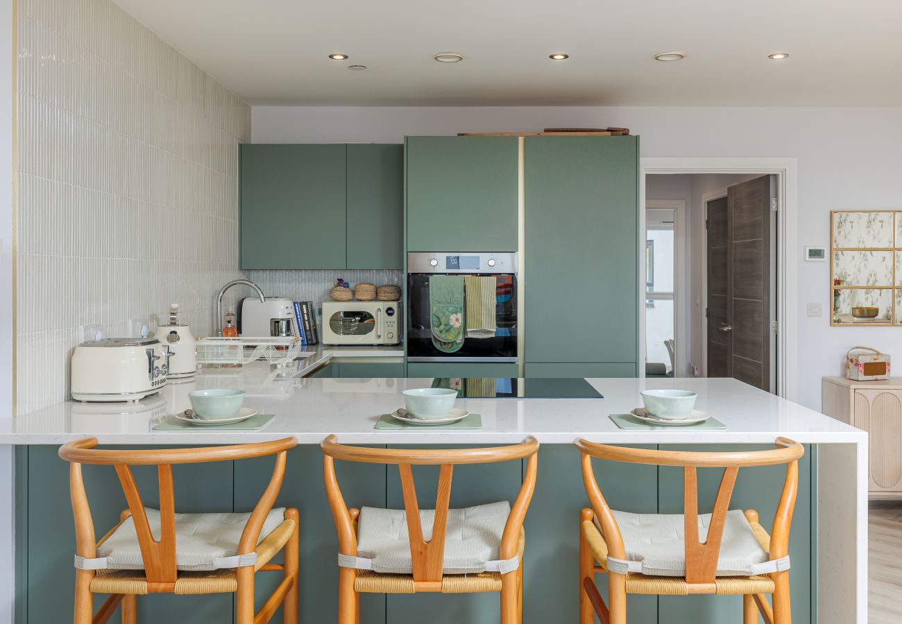 Modern kitchen and breakfast bar at Hummingbird, a two-bedroom ground-floor apartment on Sandown seafront.