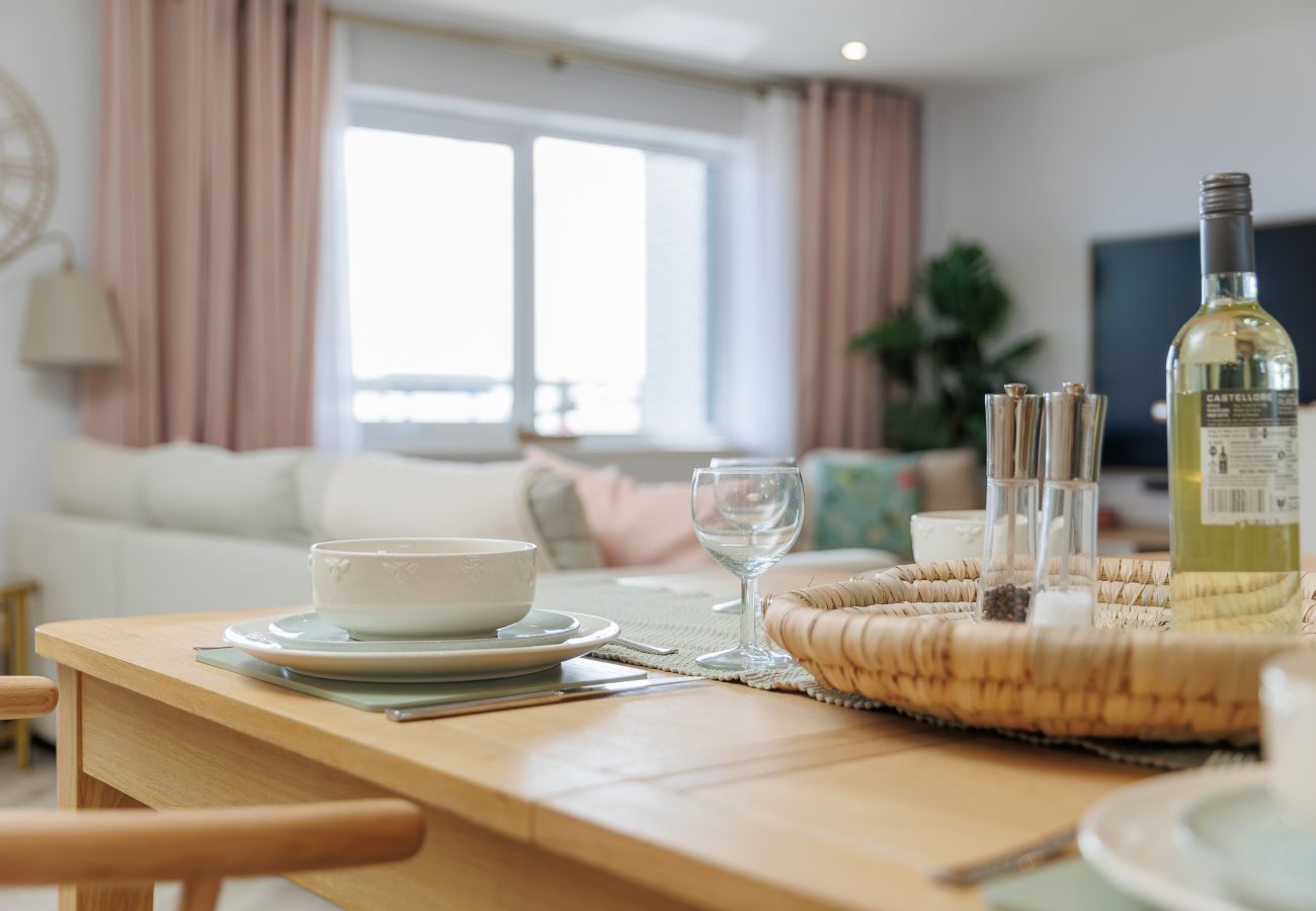 Dining table and comfortable living room at Hummingbird, a two-bedroom ground-floor apartment on Sandown seafront.