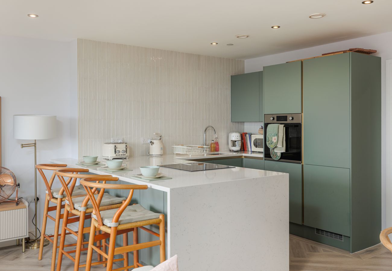 Fully equipped kitchen with breakfast bar at Hummingbird, a two-bedroom ground-floor apartment on Sandown seafront.