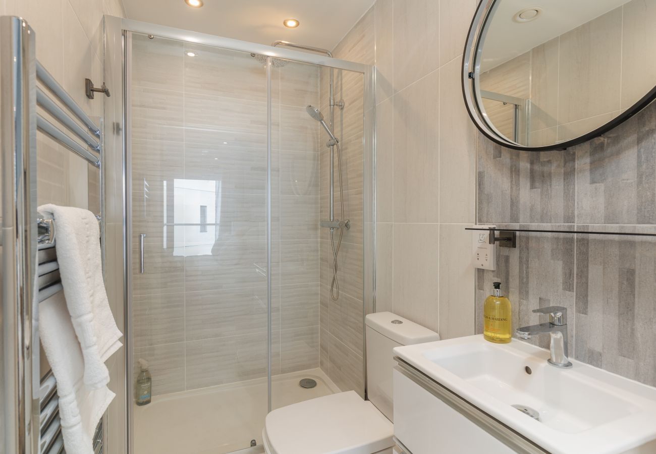 Modern en suite bathroom with a walk-in shower at Hummingbird, Sandown seafront.
