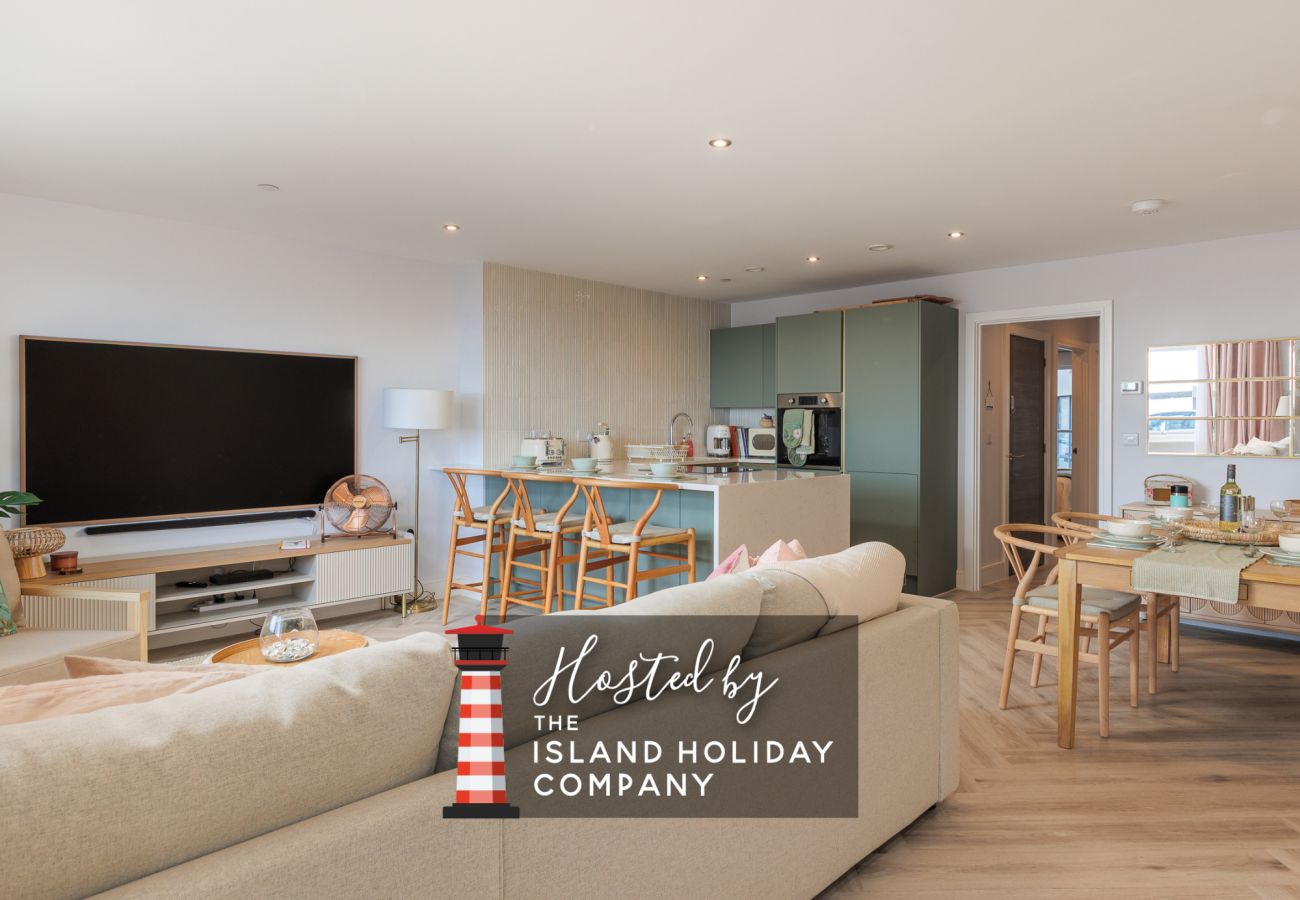 Open-plan living room, kitchen and dining area at Hummingbird, a two-bedroom ground-floor apartment on Sandown seafront.